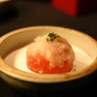 Whole Tomato with potato sause and melted cheese in a bowl.