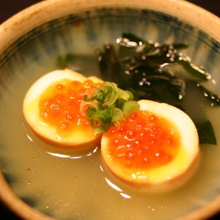 Half raw egg ont the bowl.