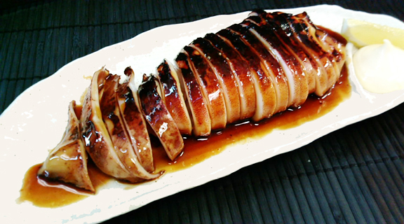 Whole squid Whole squid with "Tare" the Yakitori sause on the dish.