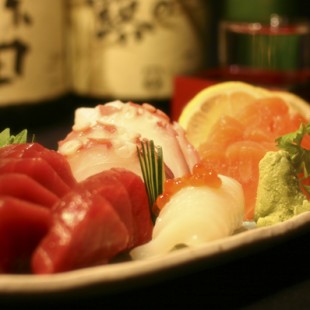 Sashimi of Octopus, Squid, Tuna and Salmon on the dish.